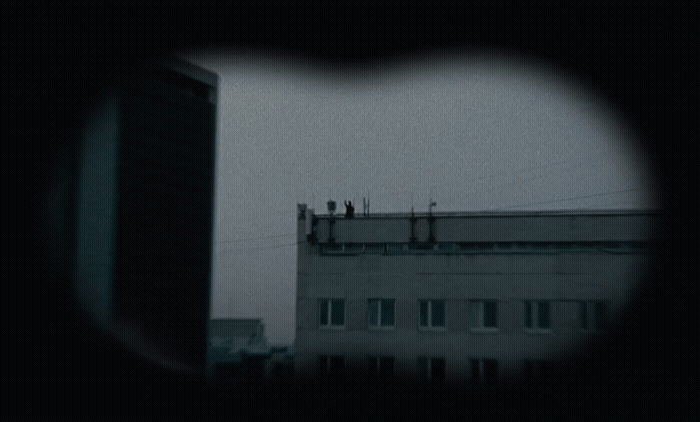 a view of a building through a hole in a window