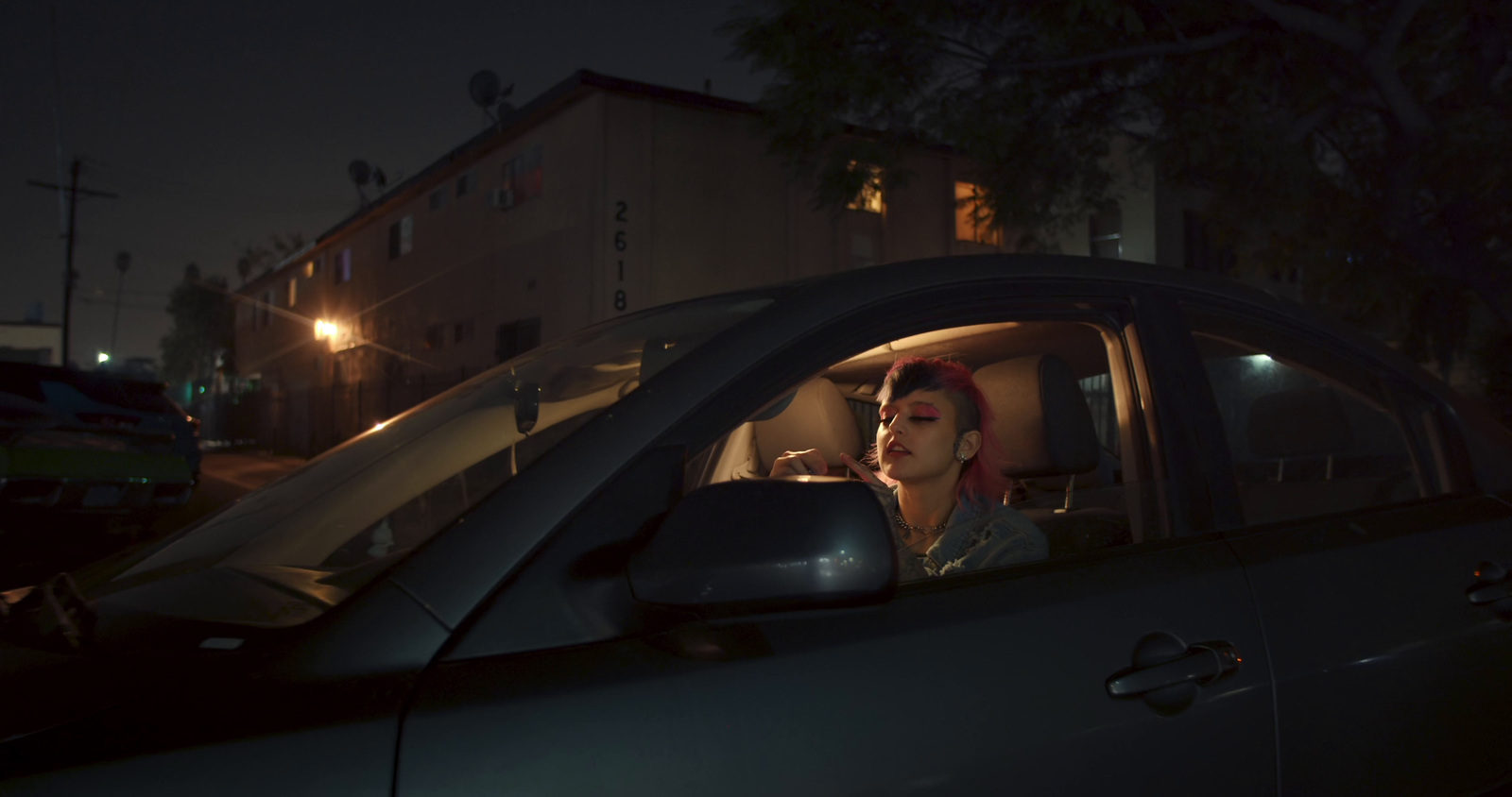 a woman sitting in a car at night