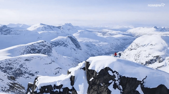 a man standing on top of a snow covered mountain