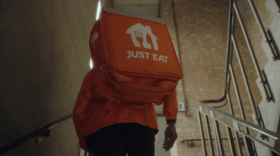 a person with a backpack walking up a flight of stairs