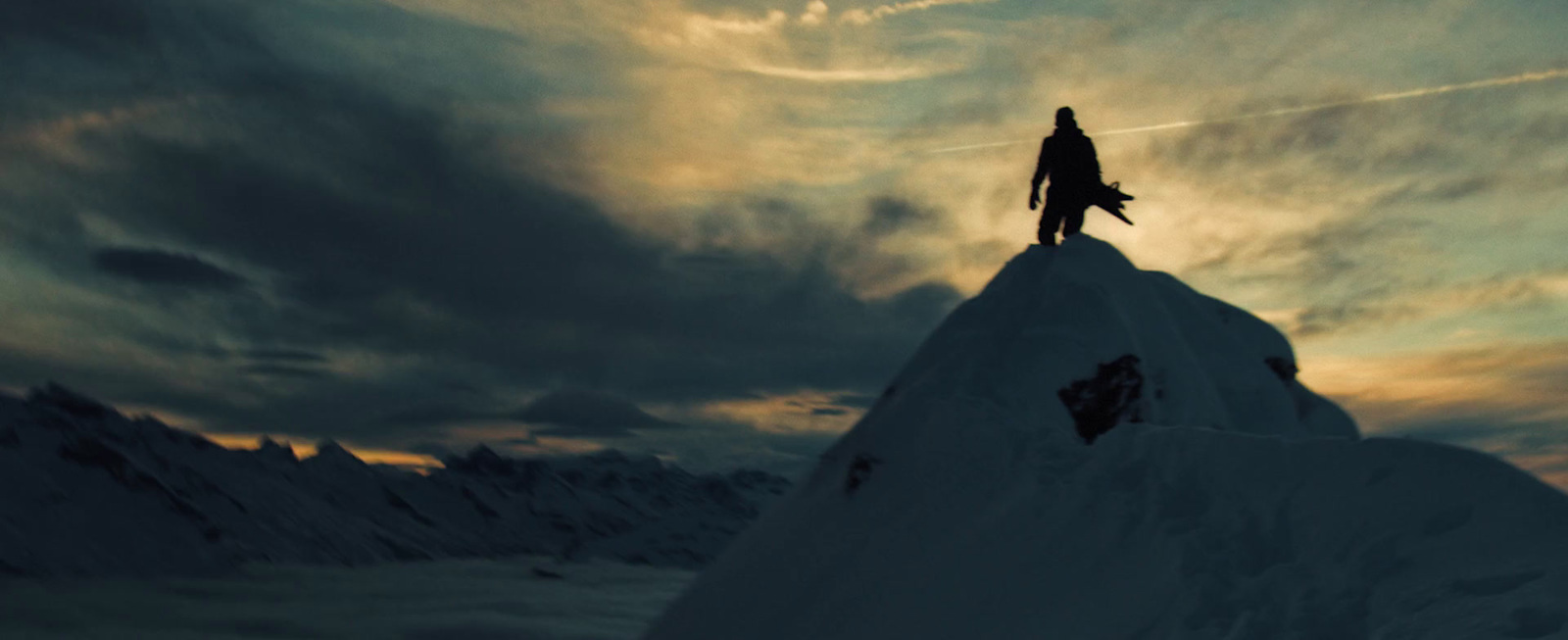 a man standing on top of a snow covered mountain