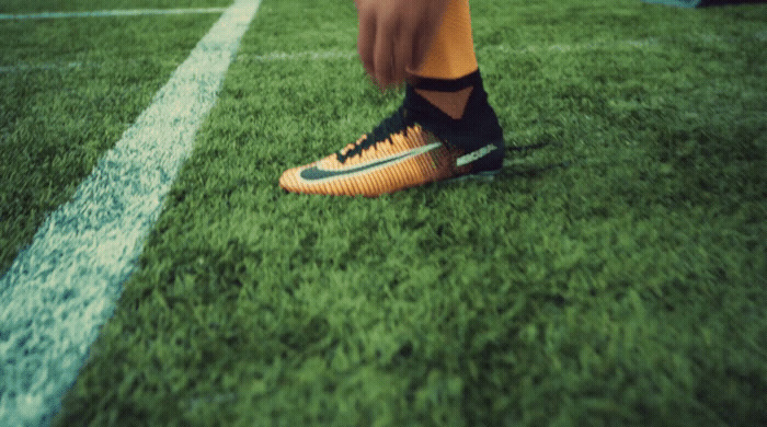 a close up of a person's feet on a soccer field