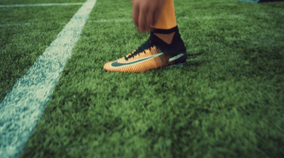 a close up of a person's feet on a soccer field