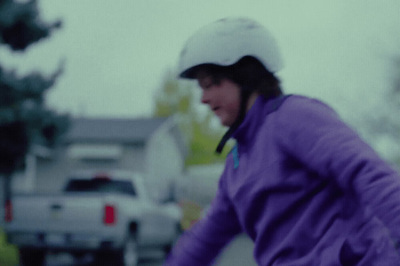 a woman riding a bike down a street