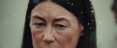 a close up of a woman's face in the rain