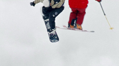 a man flying through the air while riding skis