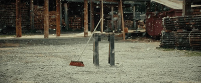 a red dustpan sitting on top of a metal pole