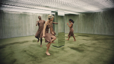 a group of women standing in front of a mirror