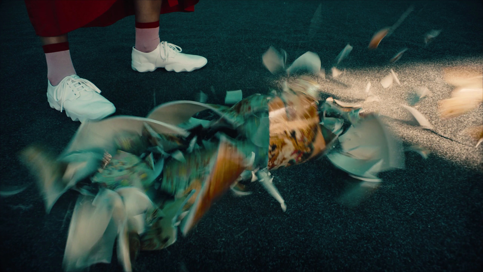 a person standing over a bunch of trash on the ground