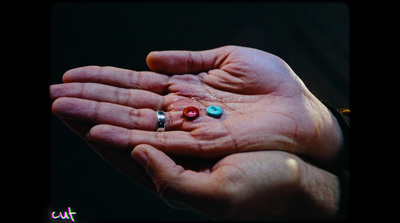 a person holding a handful of pills in their hands