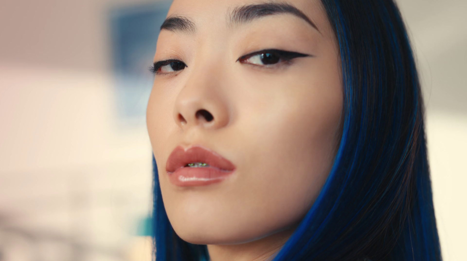 a close up of a woman with blue hair