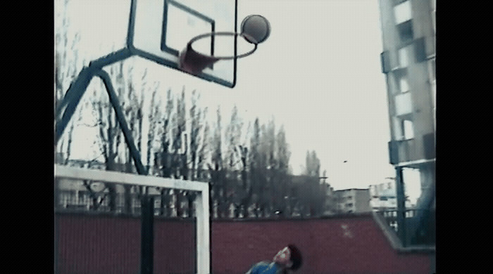 a man is playing basketball in a basketball court