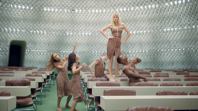 a group of women standing next to each other in a room