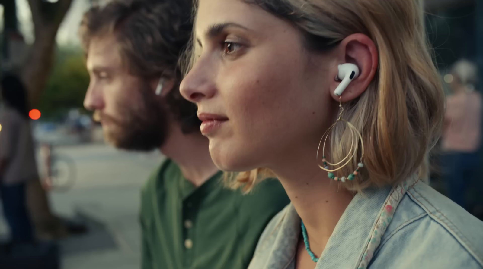 a man and a woman wearing ear buds