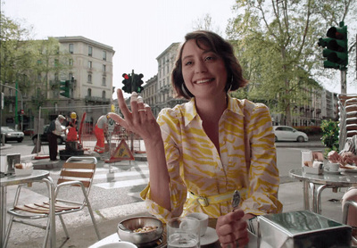 a woman sitting at a table with a plate of food