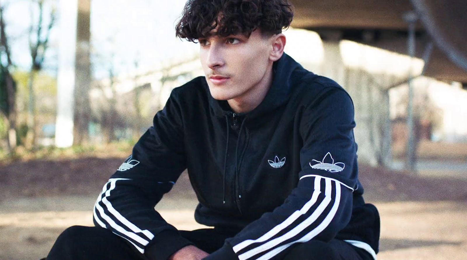 a young man sitting on top of a skateboard