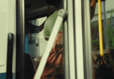 a person standing on a bus looking out the window