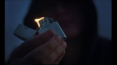 a person holding a lighter in their hand