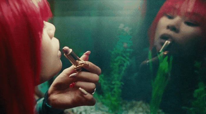 a woman with red hair is smoking a cigarette