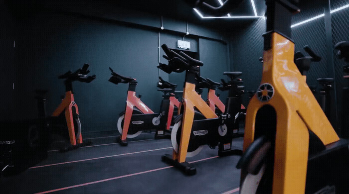 a row of exercise bikes in a gym