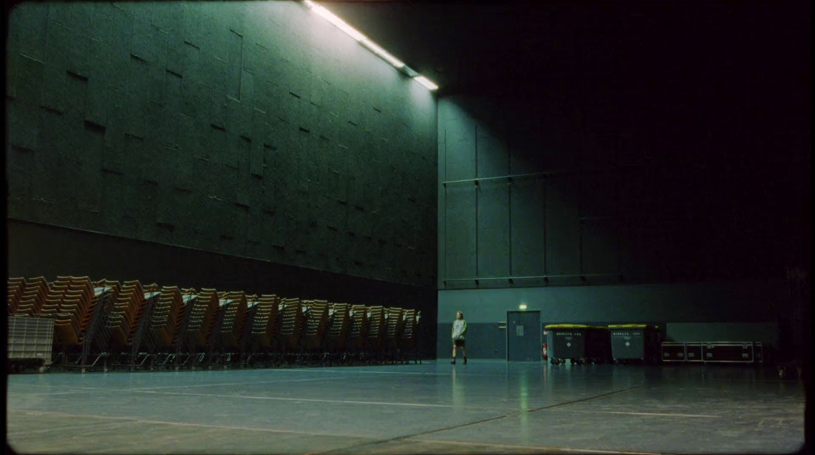 a person standing in front of a row of chairs