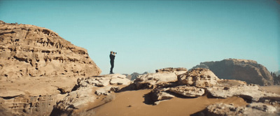 a man standing on top of a rocky mountain