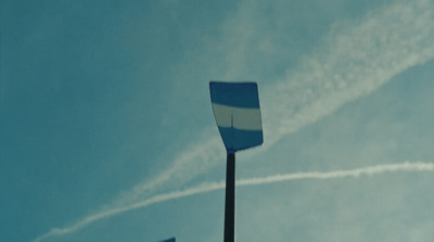 a blue and white flag flying in the sky