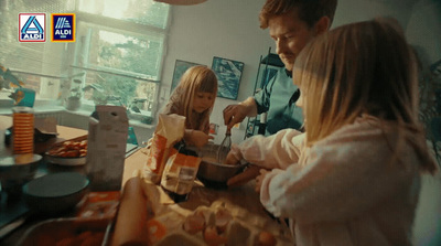 a man and two little girls making food together