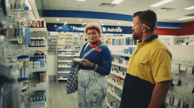 a man and a woman standing in a store