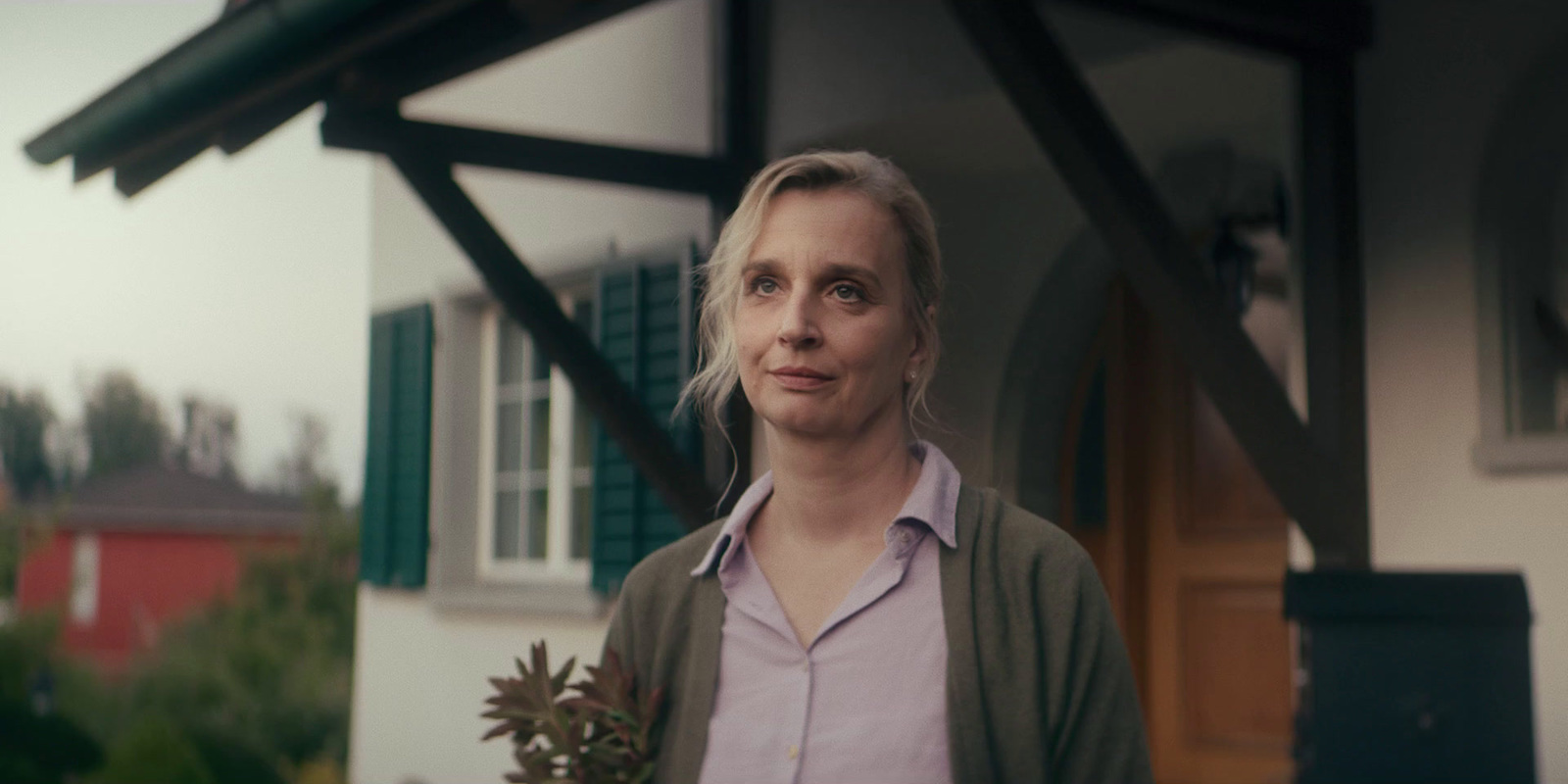 a woman standing in front of a house