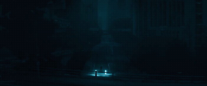 a person standing in the middle of a street at night