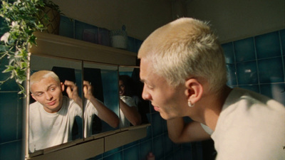 a man looking at himself in the mirror