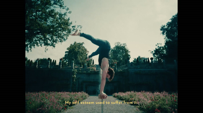 a person doing a handstand on a pole