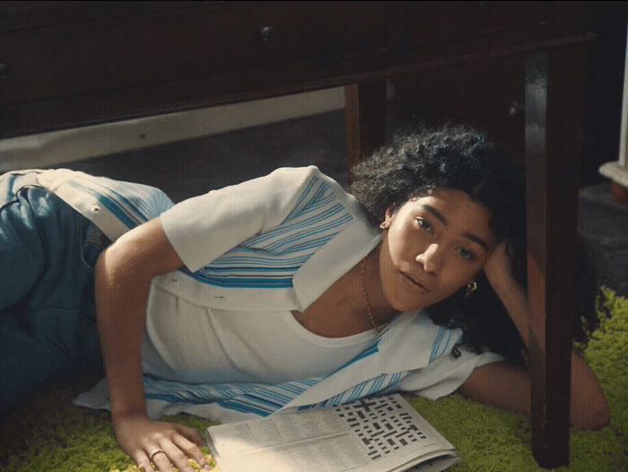 a woman laying on the ground next to a table