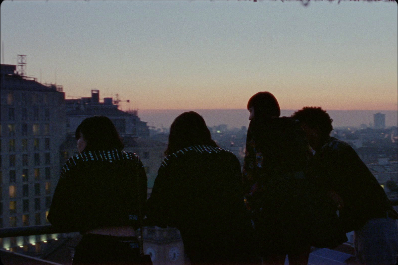 a group of people standing on top of a building