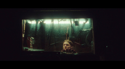 a woman standing in front of a tv in a dark room