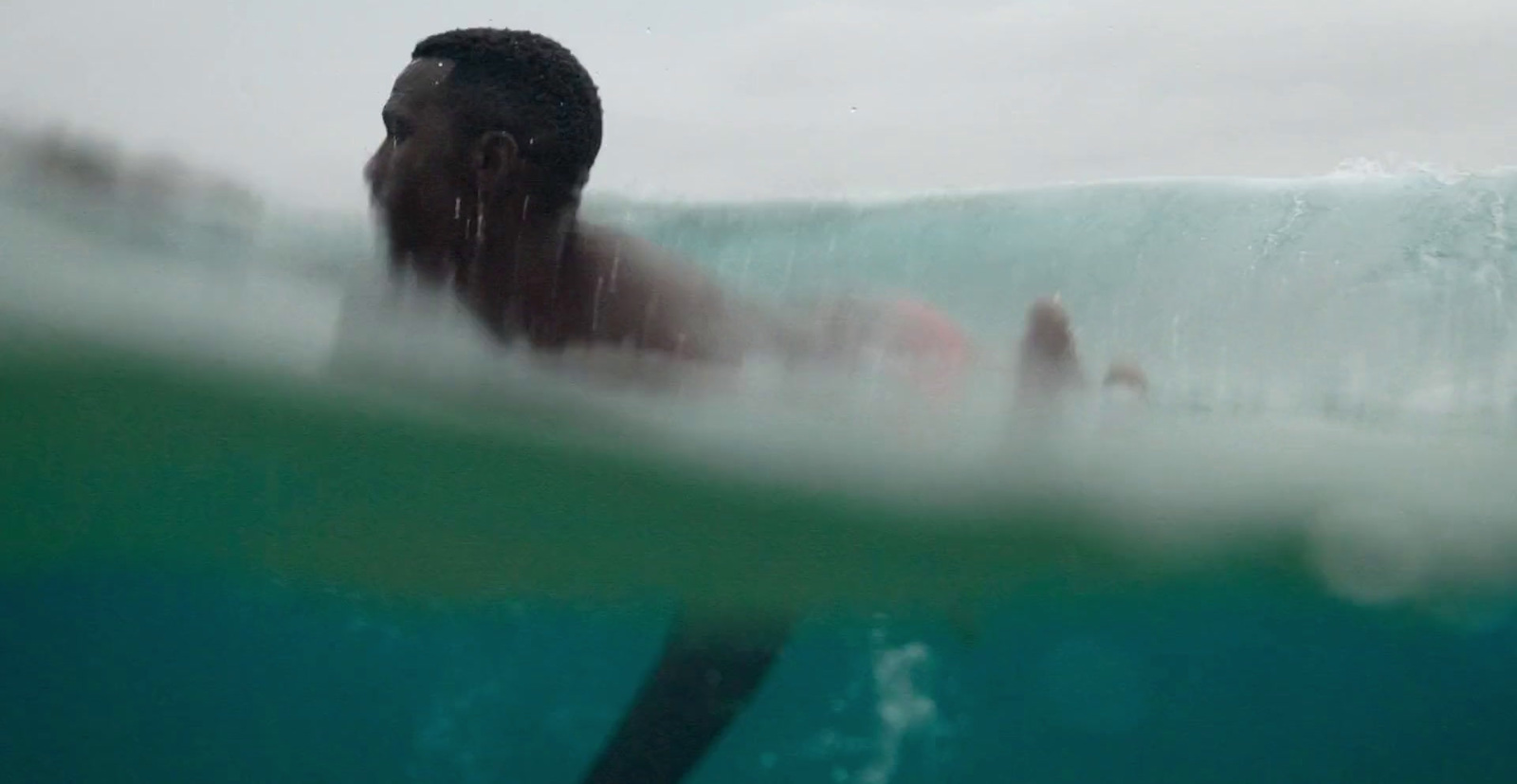 a man riding a wave on top of a surfboard