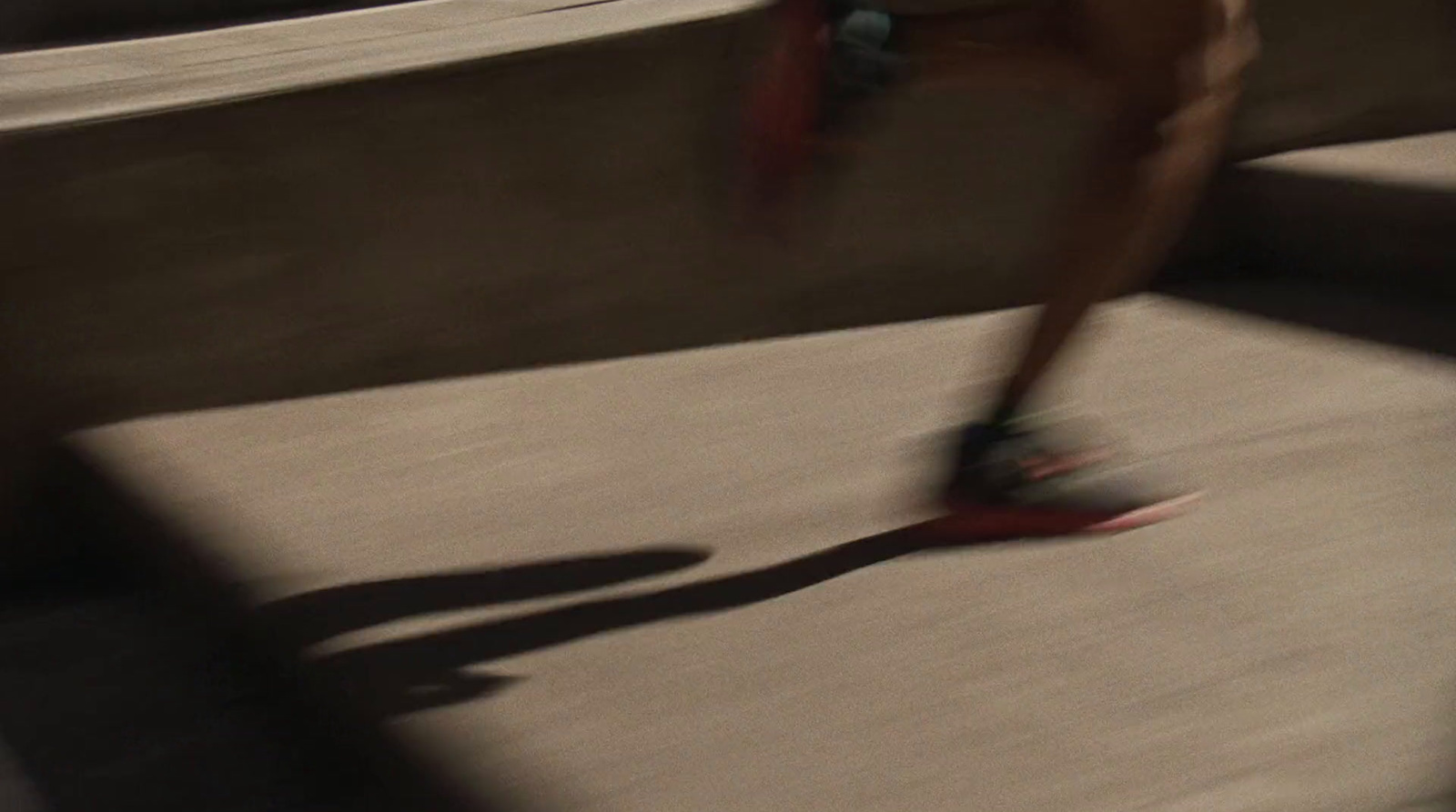 a person riding a skateboard down a cement ramp