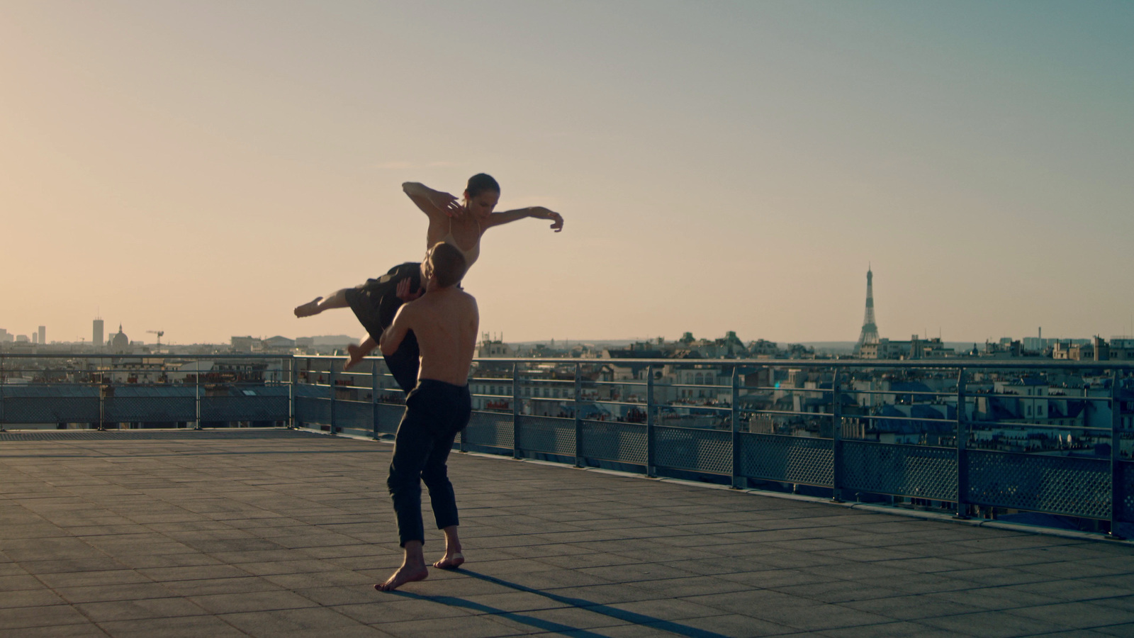 a man doing a handstand on top of a roof