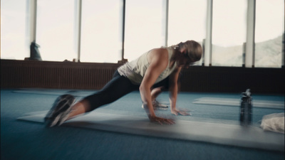 a woman is doing push ups on a mat