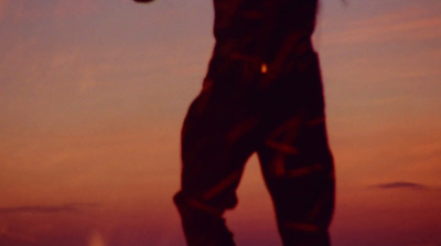 a silhouette of a person holding a frisbee