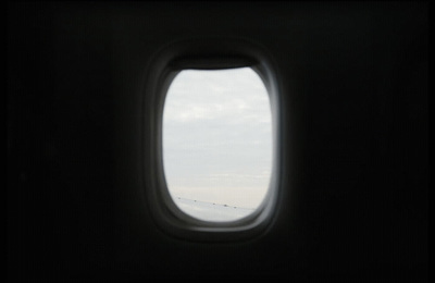 an airplane window with a view of the sky