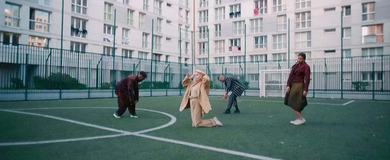 a group of people standing on top of a basketball court