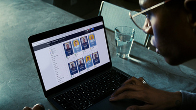 a man sitting in front of a laptop computer