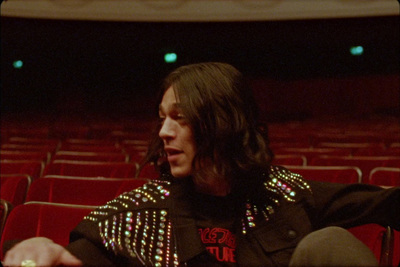 a person sitting in a chair in a theater