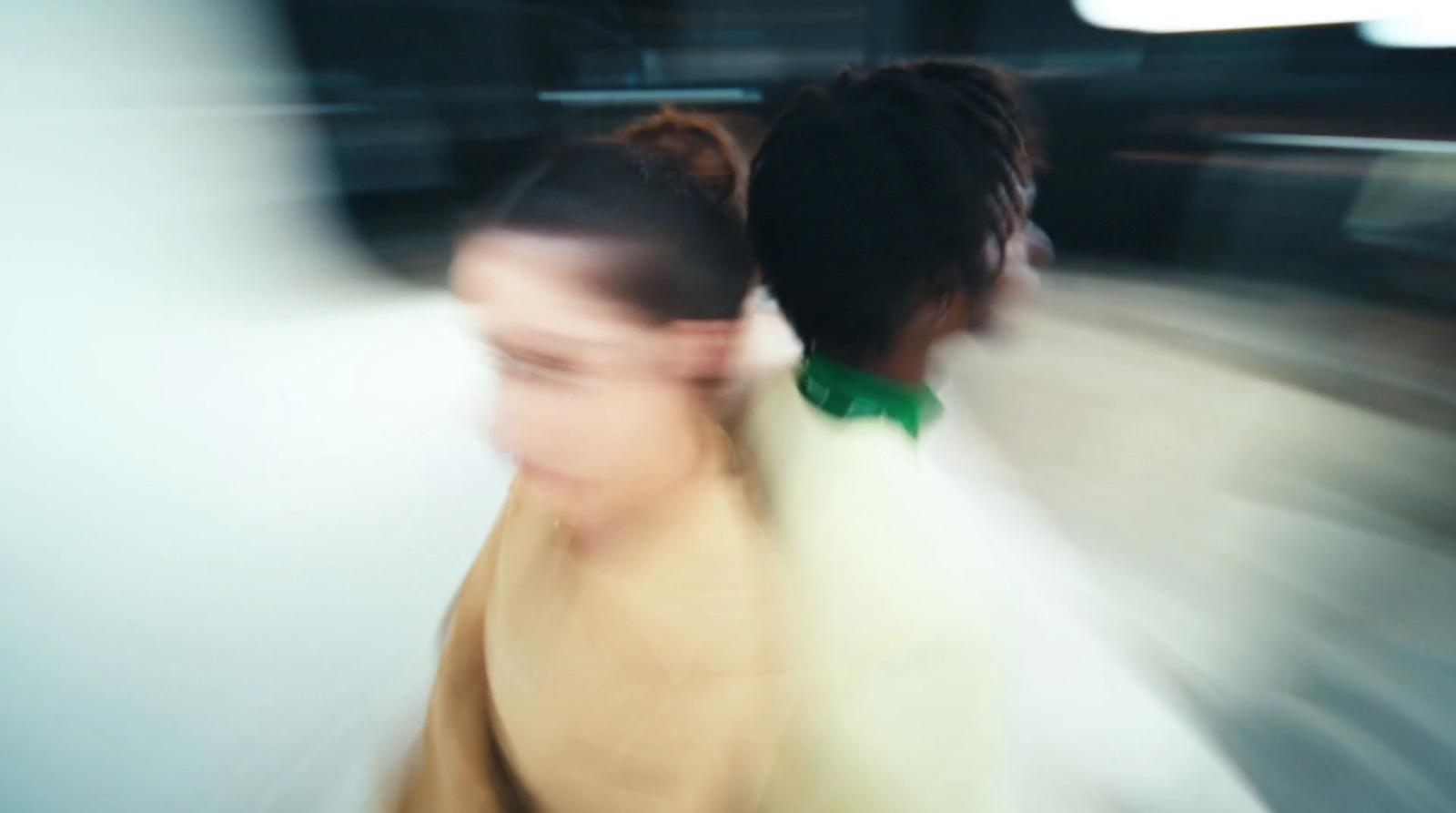 a blurry photo of two women walking down a street