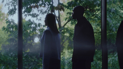 a man and a woman standing in front of a window