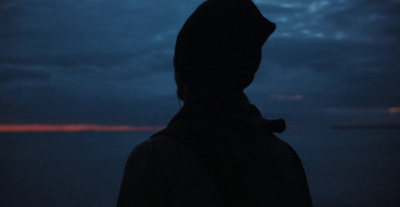 a person standing in front of a dark sky