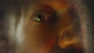 a blurry photo of a man's face with green eyes