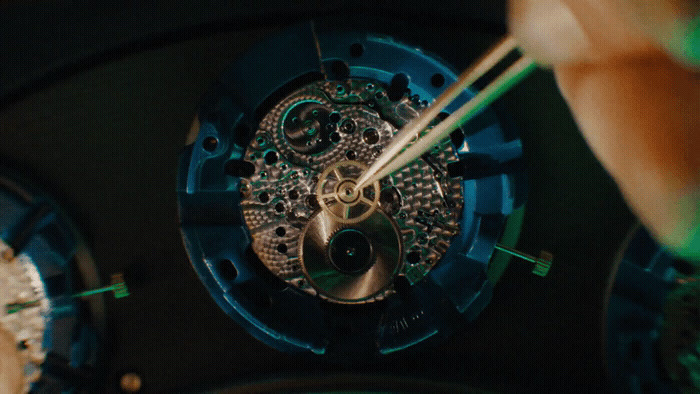 a close up of a person holding a clock